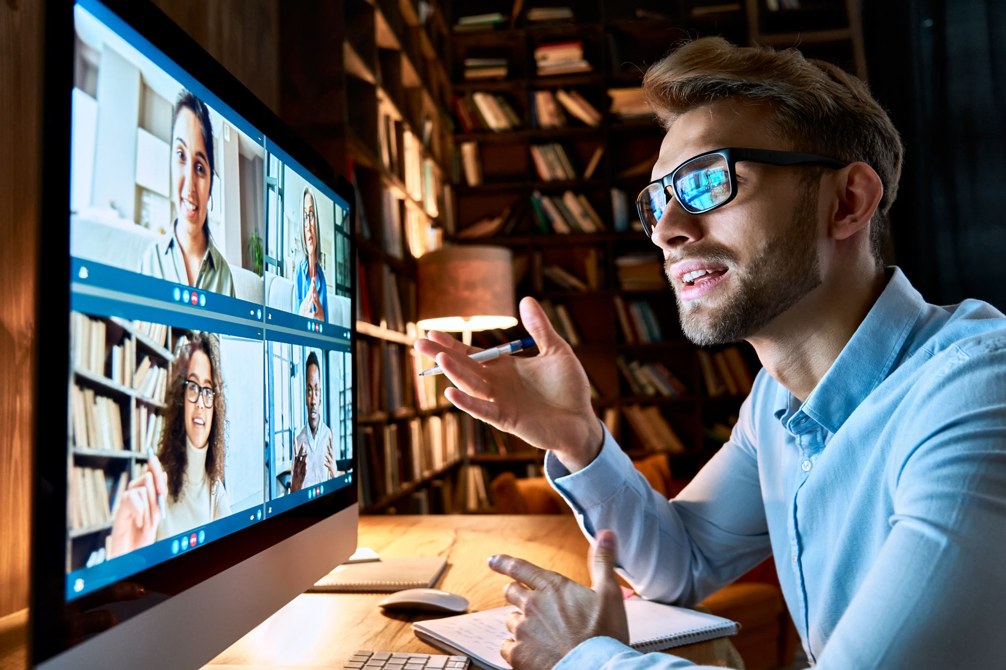 Man in front of 4-person video conference chat