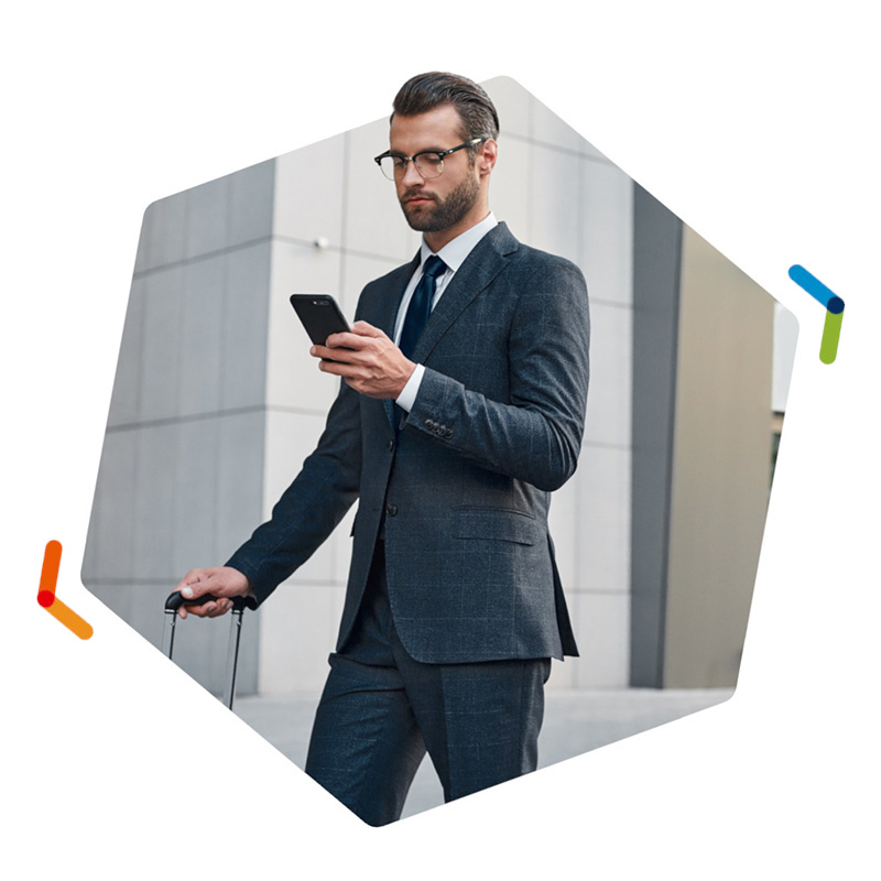 Businesman walking while looking at his smartphone
