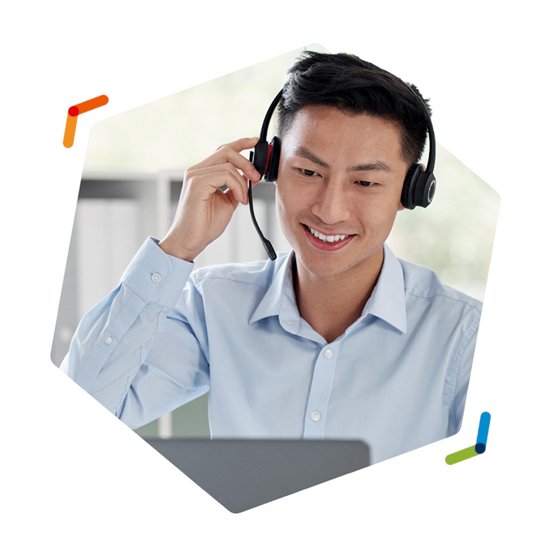 Smiling call center employee wearing VoIP headset