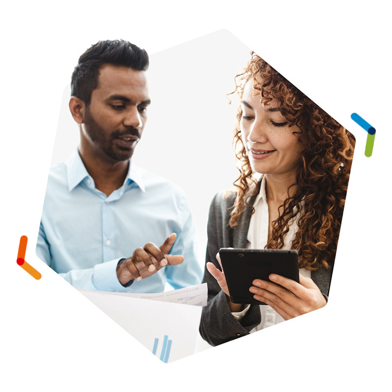Two co-workers collaborating together over a smart tablet