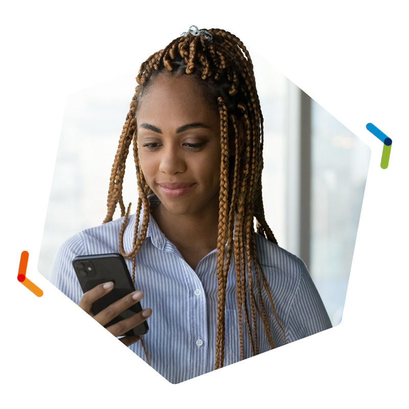 Businesswoman looking down at smartphone in her right hand