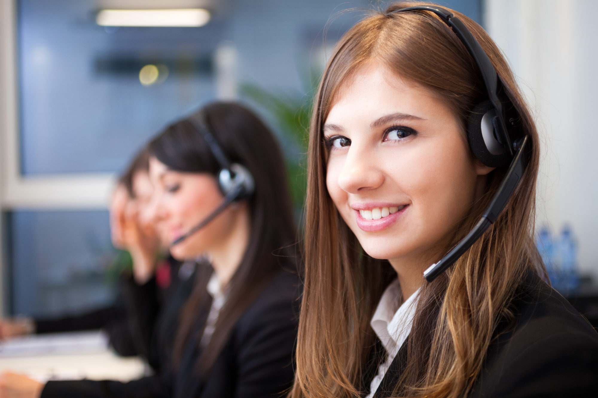 Smiling customer support operator with headset