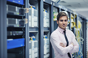 man standing next to servers