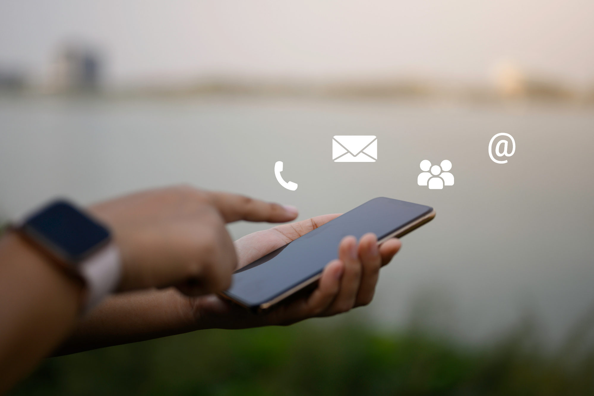 Businessman using a mobile phone with floating icons in the air